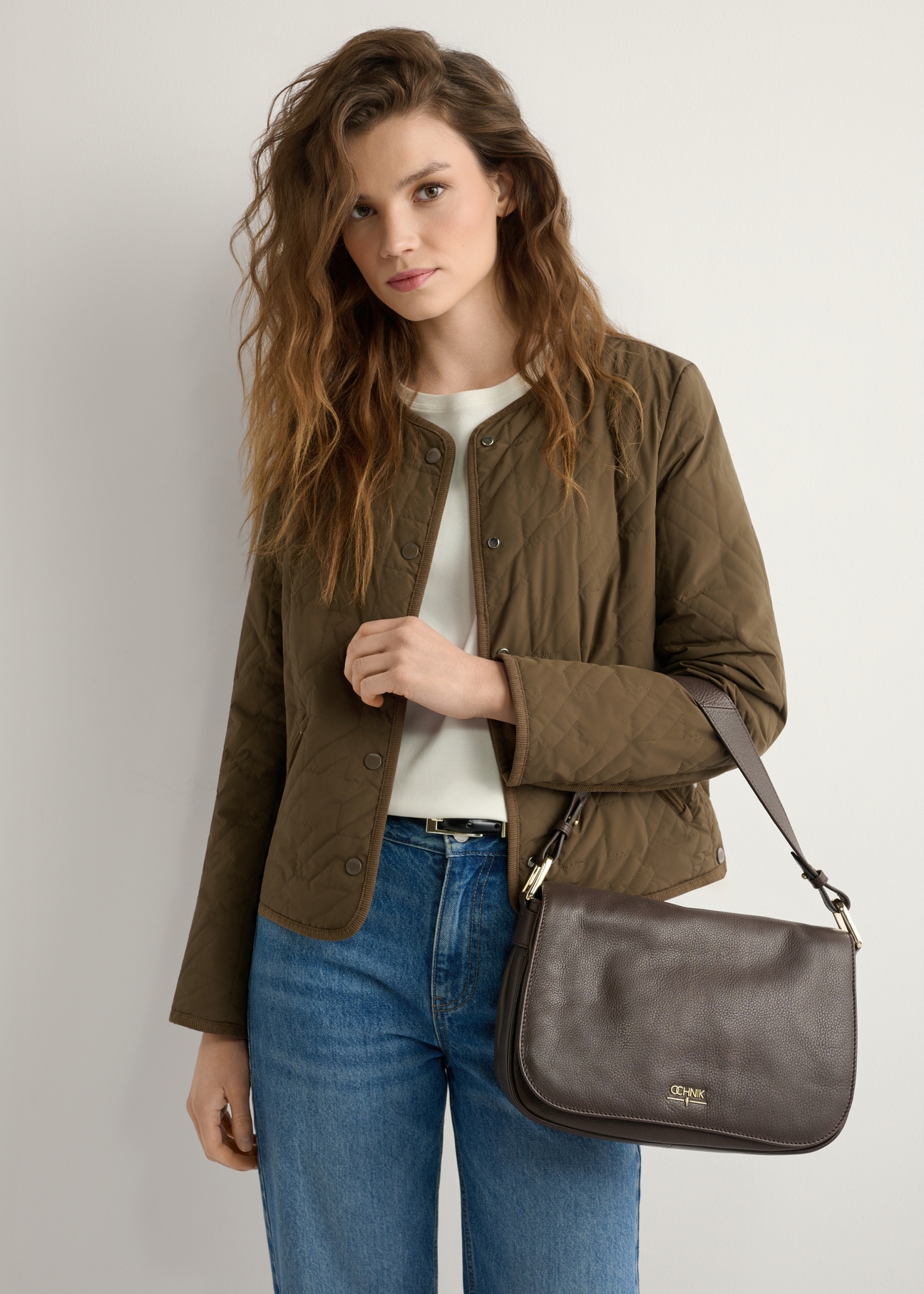 Жіноча коричнева шкіряна сумка-месенджер TORES-1253-1I(W26), вигляд виробу на плечі моделі. Видно половину силуету.