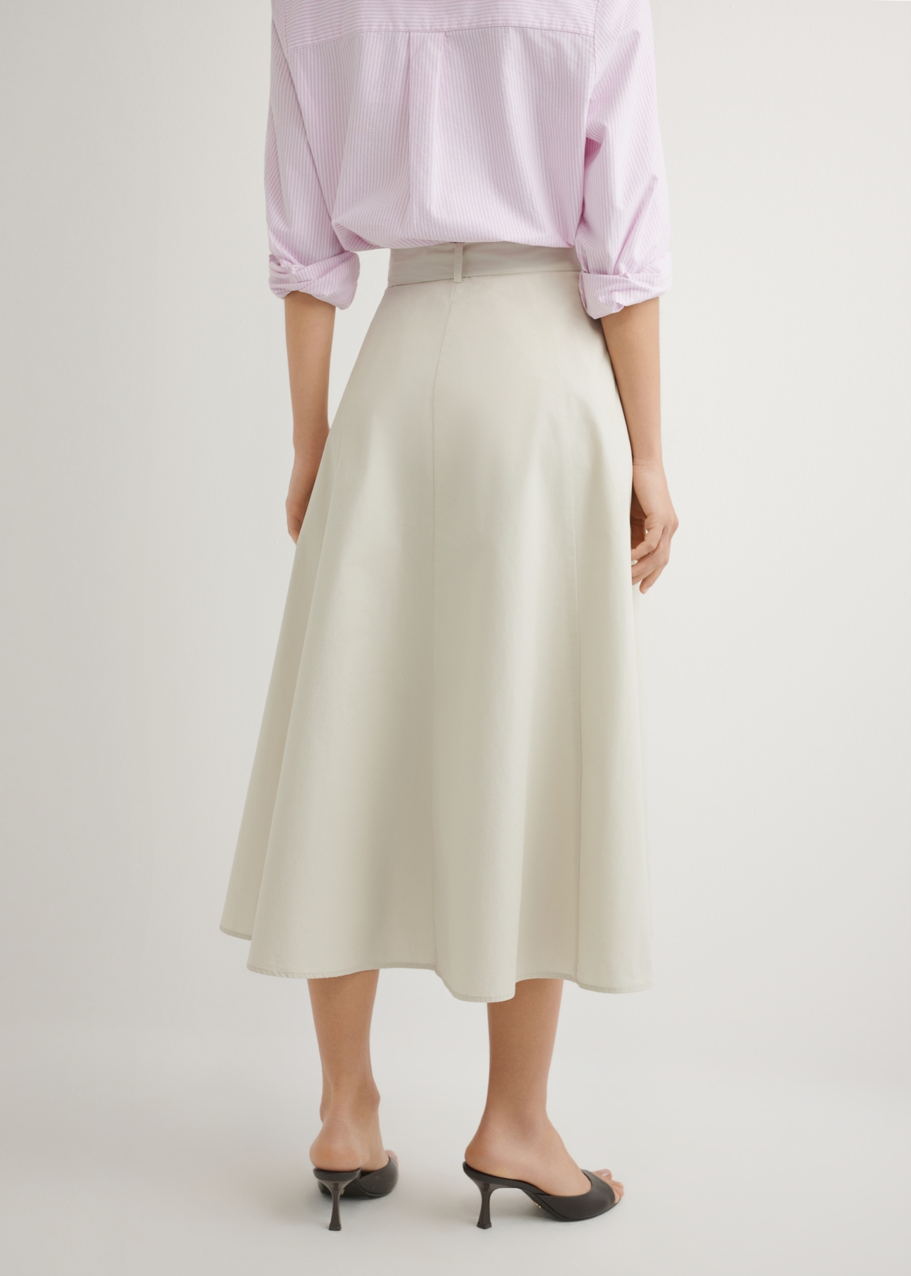 Бежева спідниця міді SPCDT-0123-1A(W26), вигляд виробу ззаду на моделі. Видно половину силуету.