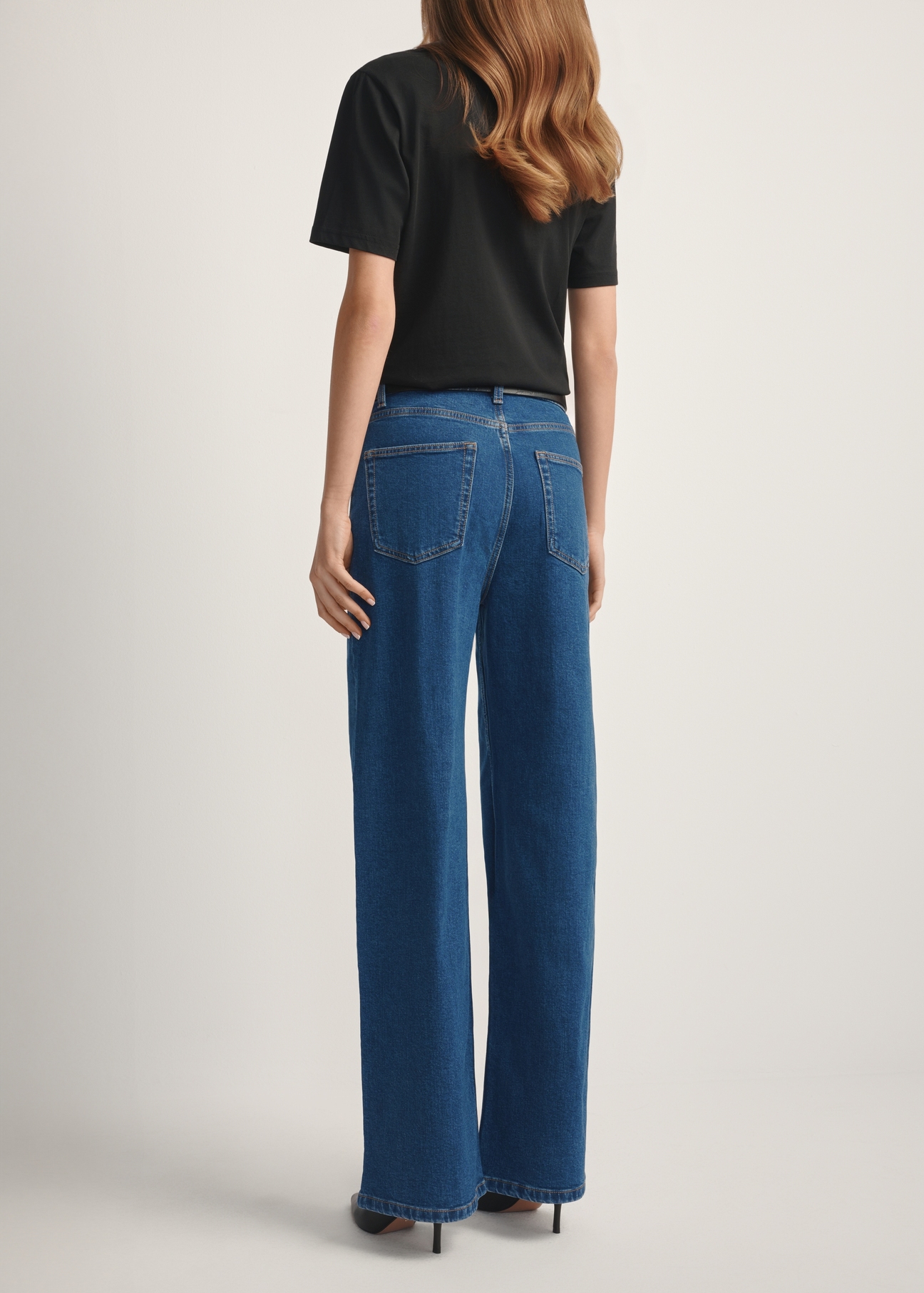 Жіночі сині джинсові штани JEADT-0014-7H(W26), вигляд виробу ззаду на моделі. Видно половину силуету.