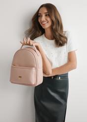 Рожевий жіночий рюкзак середнього розміру TOREC-0920-5A(W26), вигляд виробу в руці моделі. Видно половину силуету.