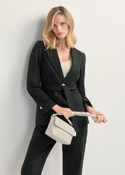 Кремова маленька жіноча сумка через плече TOREC-0916-0B(W26), вигляд виробу спереду в руці моделі. Видно половину силуету.