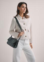 Чорна класична жіноча сумка TOREC-1124-99(W26), вигляд виробу спереду на плечі моделі. Видно половину силуету.