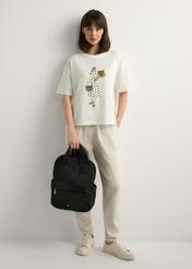 Чорний нейлоновий жіночий рюкзак TOREN-0341-99(W26), вигляд виробу в руці моделі. Видно все тіло.