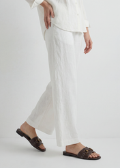 Жіночі темно-коричневі шкіряні шльопанці BUTYD-1273-1I(W26), вигляд виробу збоку на ногах моделі. Видно половину силуету.